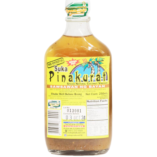 Bottle of Suka Pinakurat with a yellow label and clear liquid.